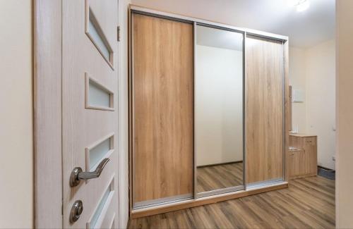 an empty room with a sliding glass door at Квартира студия 1 комнатная на Теремках низкий этаж in Kyiv