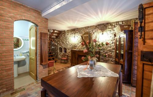 a room with a table with a vase of flowers on it at 2 Bedroom Beautiful Home In Corciano in Corciano