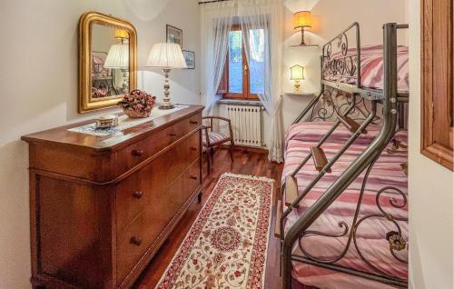 a bedroom with a bunk bed and a dresser with a mirror at 2 Bedroom Beautiful Home In Corciano in Corciano