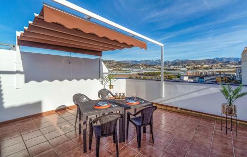 a patio with a table and chairs on a balcony at Beautiful Apartment In Torrox in Torrox