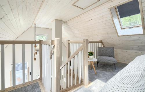 a room with a bed and a chair and a window at Cozy Apartment In Tlen With Kitchen in Tleń