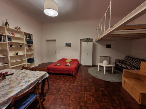 a living room with a red bed and a couch at La Casa a Trastevere in Rome