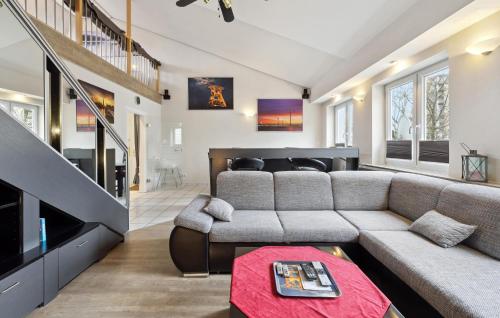 a living room with a couch and a tv at 2 Bedroom Nice Apartment In Bremerhaven in Bremerhaven