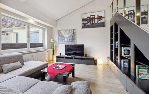 a living room with a couch and a tv at 2 Bedroom Nice Apartment In Bremerhaven in Bremerhaven