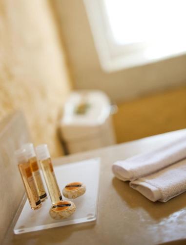 a table with two bottles and towels on a table at Morro Alacati in Alacati