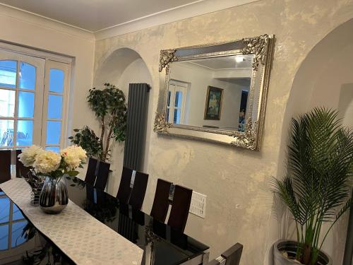 a dining room with a mirror and a table and chairs at Contractors accommodation near John Lennon Airport in Liverpool