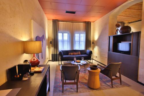 a living room with a couch and a table and chairs at Carus Cappadocia in Goreme