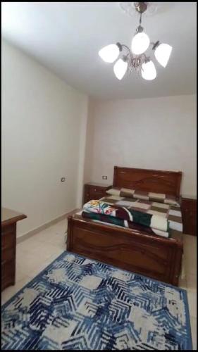 una camera con letto e ventilatore a soffitto di شقة مفروشة مميزة جدا a Mît Khamîs