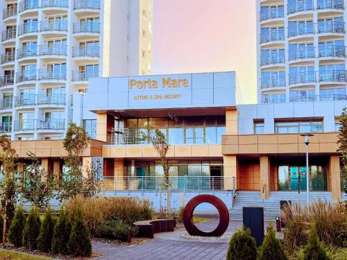 a building with a large red circle in front of it at White Suite, 50 meters to beach, 10th floor, beautiful view, Baltic Best in Dziwnówek