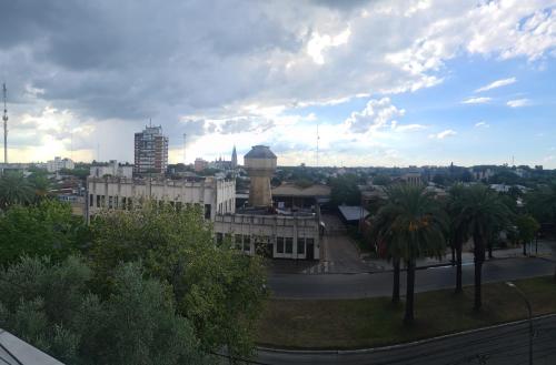 a view of a city with a building and a clock tower at Humberto Apart B in Luján