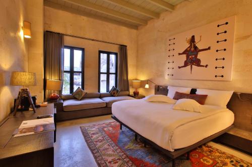 a bedroom with a large bed and a living room at Carus Cappadocia in Goreme