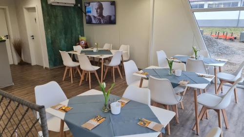 a room with blue tables and white chairs at Lins B&B Hotel Resort in Marktlustenau