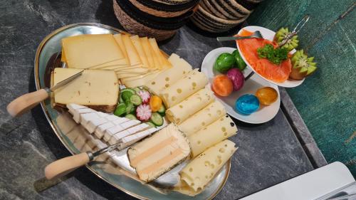a plate of cheese and other foods on a table at Lins B&B Hotel Resort in Marktlustenau