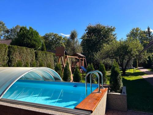 a swimming pool in a yard with a fence at Ubytování v apartmánech pod Radhoštěm in Prostřední Bečva