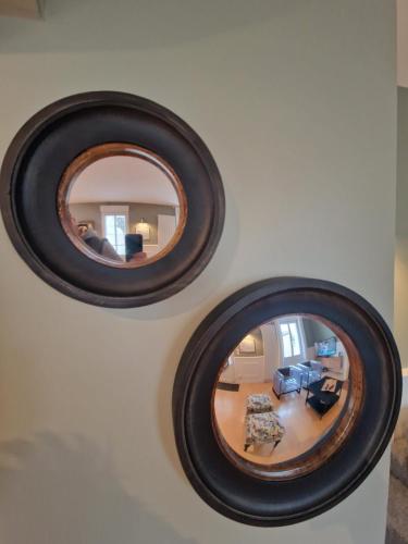 two mirrors on a wall with a living room at "Ô Tour's Angels" A Côté in Tours