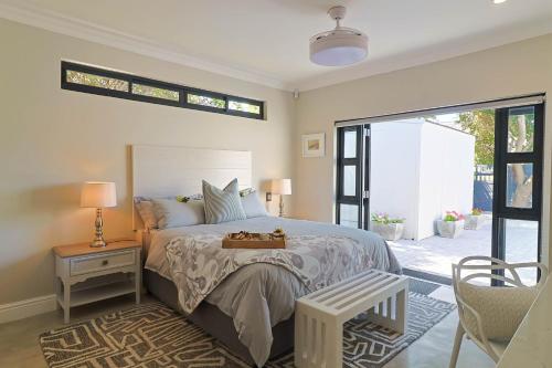 a bedroom with a large bed and a sliding glass door at Saffron House in Hermanus