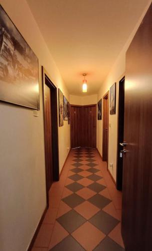 a hallway with a checkered floor in a building at Guest House Sherpa in Moravská Třebová