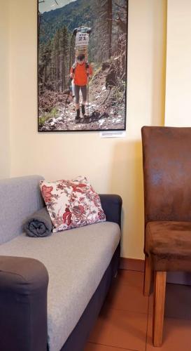 a couch in a room with a picture of a person on skis at Guest House Sherpa in Moravská Třebová