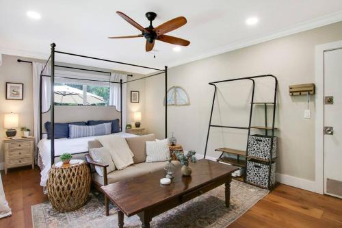 a living room with a couch and a bed at Downtown WPB studio D - w full kitchen in West Palm Beach