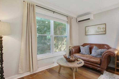 a living room with a couch and a window at Cozy Studio Downtown WPB -Unit C in West Palm Beach