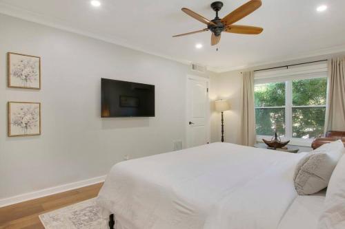 a white bedroom with a bed and a ceiling fan at Cozy Studio Downtown WPB -Unit C in West Palm Beach