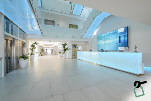 an empty lobby of a building with a reception desk at HOTIDAY Room Collection - Tirrenia in Tirrenia