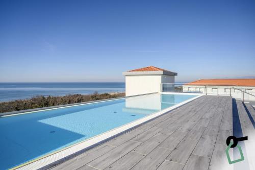 a swimming pool on the roof of a house at HOTIDAY Room Collection - Tirrenia in Tirrenia