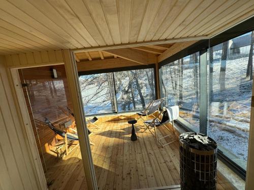 Posezení v ubytování Chalet de luxe avec Sauna chez Papou
