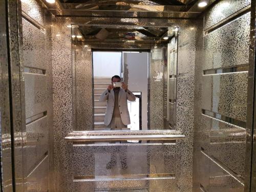 a man taking a picture of himself in a mirror at Shahed Apartment in Amman