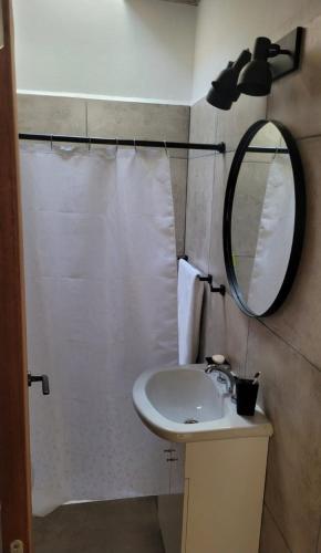 a bathroom with a sink and a mirror at Casa Buda in Almafuerte