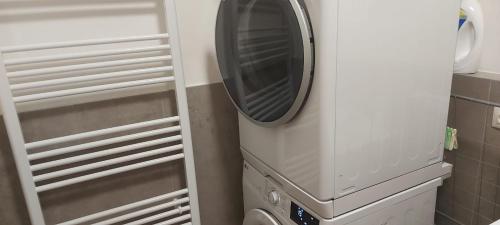 a washer and dryer in a small kitchen at 3 room Apartment 2x balcony, new building, 21 in Bratislava