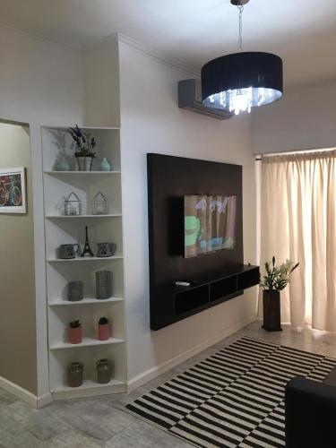 a living room with a flat screen tv on a wall at Apartamento frente al mar in Mar del Plata