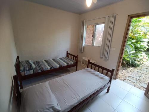 um quarto com duas camas e uma janela em Pousada Villa da Nascente em Florianópolis