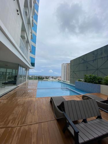 a swimming pool on the roof of a building at Cozy and Convenient studio unit @ Inspiria condominium in Davao City