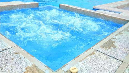 a swimming pool with blue water in it at Suite con Vista al Mar, Piscinas, Jacuzzi, Wifi in Playas