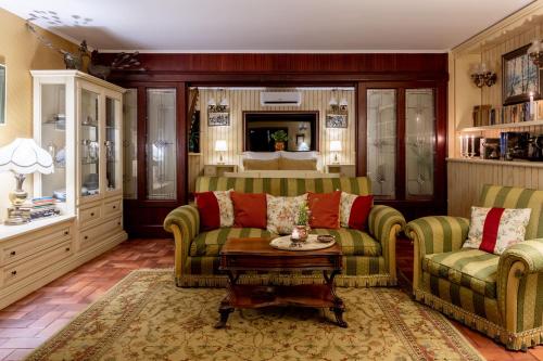 a living room with two couches and a table at Conacul Malul Alb in Râmnicu Vâlcea