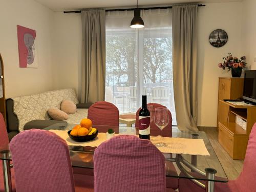 a living room with a table with a bottle of wine at City Center Suite Novalja in Novalja