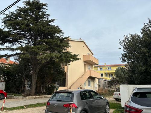 a silver car parked in front of a house at City Center Suite Novalja in Novalja