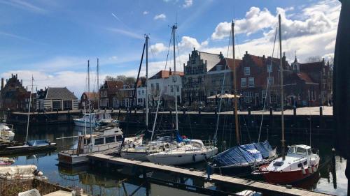 a group of boats docked in a harbor with buildings at Costa Linda B&B in Vlissingen
