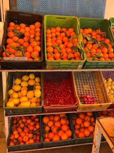 a display of oranges and other fruits in baskets at Dar Yessine Boutique Hôtel in Sousse