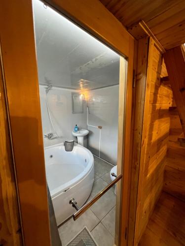 a bathroom with a bath tub and a sink at Mtirala Glamping in Ch'ak'vist'avi