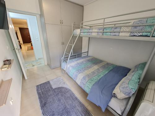 two bunk beds in a small room with a mirror at Evi's & George's Home in Athens