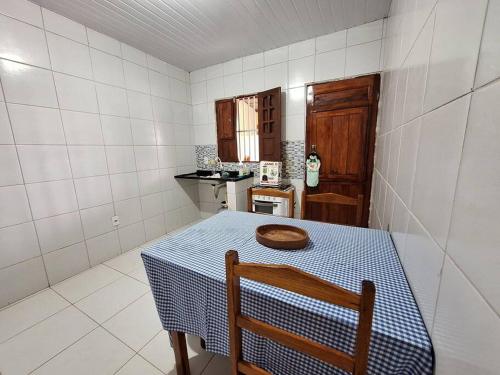 a small kitchen with a table with a blue and white at Casa de Avinha in Sirinhaém