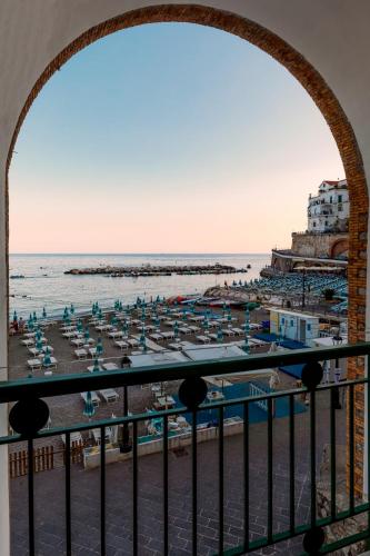 a view of a beach with chairs and umbrellas at La Piccola Atrani in Atrani