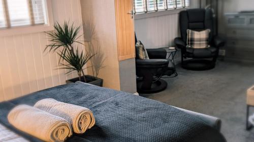 two rolled towels on a bed in a room at Croyland Guest House in Tenby