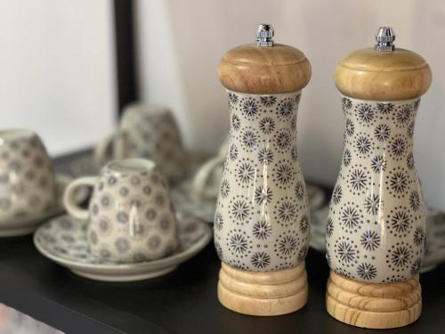 a group of vases sitting on a shelf at Great Living Apartments in Karlovy Vary