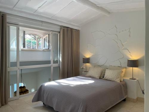 a bedroom with a bed and a window at Private Villa in Quinta da Marinha with golf view! in Cascais