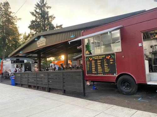 a red food truck parked in front of a restaurant at West Linn Relaxing Entire Home WiFi TV Yard BBQ Eateries in West Linn