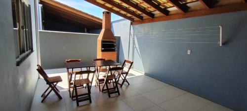 a dining room with a table and chairs at Pousada e Casa Praias de Penha in Penha