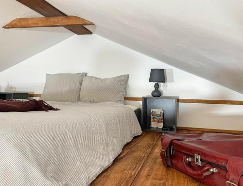 a bedroom with a bed and a red suitcase at Holiday home Sukha in Grabrovnik